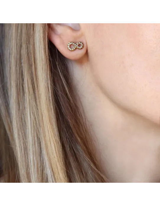 Pendientes Anartxy Sintán · Diseño infinito en acero con circonitas dorado y plateado